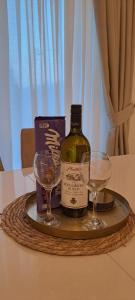 a tray with a bottle of wine and two glasses at Lux Apartment Jovanovic in Tivat