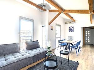 een woonkamer met een bank en een tafel bij Appartement 3 chambres à proximité des plages in Cannes