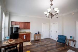 a living room with a dining table and a kitchen at Unique 1 BR 1BA Stay in Downtown - 204 in Champaign