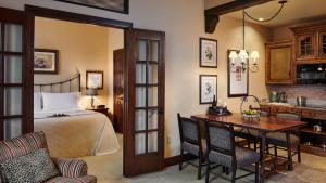a bedroom with a bed and a table and chairs at Hotel Granduca Houston in Houston