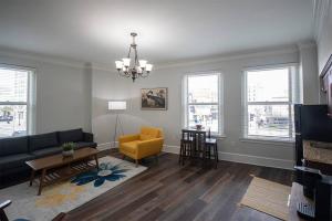 a living room with a couch and a chair at Unique 1 BR 1BA Stay in Downtown - 204 in Champaign