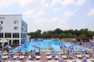 a large pool at a hotel with people sitting around it at Flamingo Resort in Belgrade