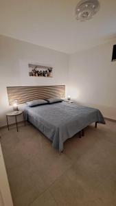 GreciにあるB&B Casa Vacanza Greciのベッドルーム1室(大型ベッド1台、青い毛布付)