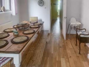 a wooden table with plates on it in a room at The Yellow House in Gorleston-on-Sea