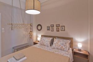 a bedroom with a large bed with two pillows at Filoxenia in athens in Athens