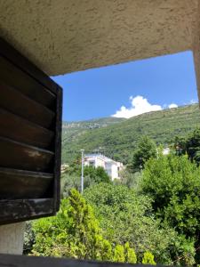 a view out of a window of a mountain at Ćetković in Petrovac na Moru