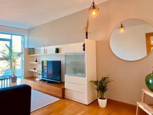 a living room with a large aquarium and a mirror at Blue Ocean Apartment in A Coruña
