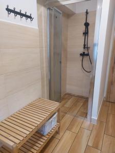 eine ebenerdige Dusche mit einer Holzbank in einem Zimmer in der Unterkunft Chalupa U přátel in Kovářská