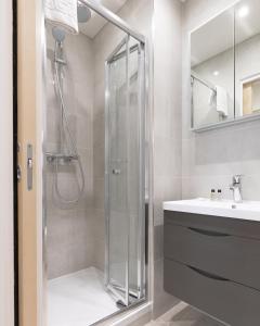 a bathroom with a shower and a sink at StayInn Stratford in London