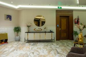 a lobby with a table and a mirror at STwin Hotel in Abha