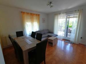 a living room with a table and a couch at Apartment & Rooms Lilis in Izola +41 photos