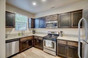 a kitchen with wooden cabinets and a stove top oven at Deluxe Serene Home with Centralized AC and Near Grocery in Chico
