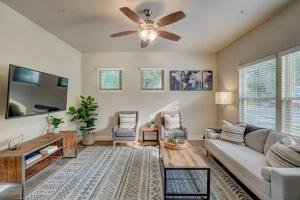 a living room with a couch and a ceiling fan at Deluxe Serene Home with Centralized AC and Near Grocery in Chico