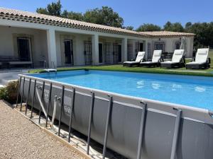 a swimming pool with lounge chairs around it at Villa Rians in Rians
