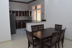 a kitchen with a dining room table and chairs at RED-36 - Al Mareekhy Villas in Salalah +21 photos