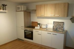a small kitchen with white cabinets and a sink at Urlaub in Engelswacht in Sundhagen-Niederhof