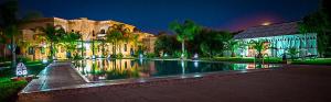a building with a swimming pool in front of a building at Las Palmeras Guest House in Marrakesh