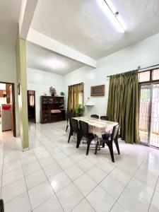 a dining room with a table and chairs at Teratai Homestay Batu Buruk in Kuala Terengganu