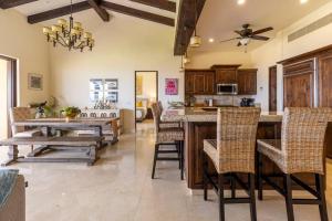 an open kitchen with a table and chairs at 3BD Golf Front Beach Club and Hot Tub in PLC in San José del Cabo