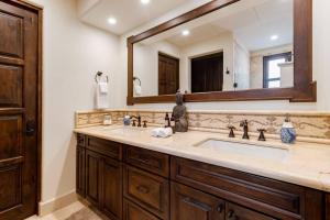a bathroom with a sink and a large mirror at 3BD Golf Front Beach Club and Hot Tub in PLC in San José del Cabo +24 photos