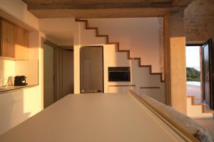 a kitchen with a staircase in a house at Aroa Eco Living Experience in Volimes