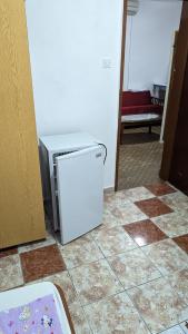 a small refrigerator sitting on the floor in a room at Private guest-house Gutic in Sutomore