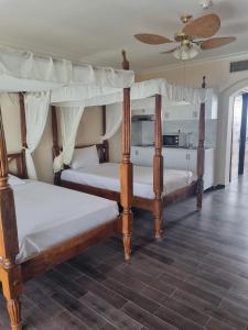 two bunk beds in a room with a ceiling at Appartamento Elisir Domina Coral Bay in Sharm El Sheikh