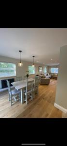 a living room with a table and chairs and a couch at Kilbarth Cottage in Haverfordwest