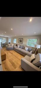 a large living room with couches and a table at Kilbarth Cottage in Haverfordwest