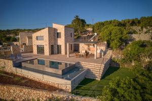an aerial view of a house with a swimming pool at Aroa Eco Living Experience in Volímai