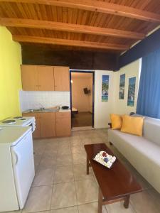 a living room with a couch and a table at Yellow Beach House in Logaras