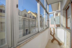a room with windows with a view of a city at Cozy and Family apartment in Lisbon