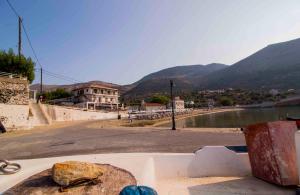 a view of a street with mountains in the background at Laconian Collection Kotronas Residence in Kotronas