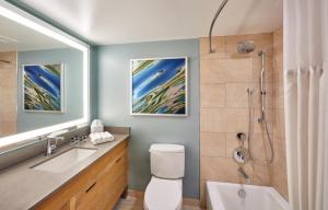 a bathroom with a toilet and a sink and a shower at Zota Beach Resort in Longboat Key