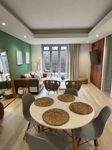 ein Wohnzimmer mit Tisch und Stühlen in der Unterkunft Stylish Bree Street Apartment - The Perfect Urban Getaway in Kapstadt