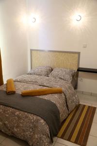 a bedroom with a large bed with two pillows at MERCURE in Saint-Quentin