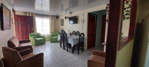 a dining room with a table and chairs at HOSTEL CASA MARINA in Puerto Limón
