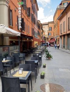 an empty street with tables and chairs and buildings at BolognaBySide-DE FALEGNAMI in Bologna +81 photos