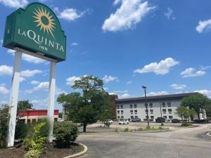 a sign for a hotel in front of a building at La Quinta Inn by Wyndham Cincinnati North in Springdale