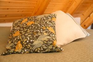 a pillow sitting on top of a bed with a blanket at Haus Jaeschke in Vetschau