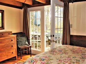 a bedroom with a bed and a sliding glass door at Heartstone Country Retreat in Buena Vista