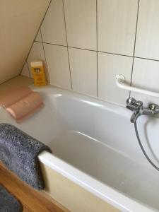 a bathroom with a bath tub with a towel at Le Clos du Vivier in Valmont +72 photos