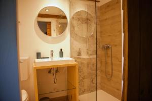 a bathroom with a sink and a shower with a mirror at 1st Truffle House Žumberak 