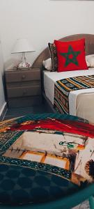 1 dormitorio con 1 cama y mesita de noche con mesa en SULTANA Beach Riad en Saidia 