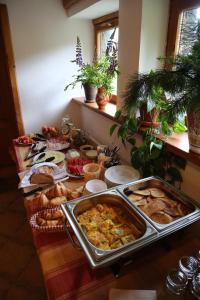 a table topped with lots of different types of food at Chata pod Sedlom Čertovica in Vyšná Boca