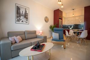 a living room with a couch and a table at Vonitsa Luxury Apartments in Vonitsa