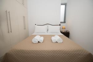 a bedroom with a bed with two towels on it at Vonitsa Luxury Apartments in Vonitsa