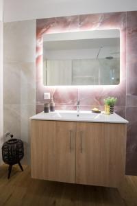 a bathroom with a sink and a mirror at Vonitsa Luxury Apartments in Vonitsa +22 photos