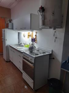 a kitchen with a stove and a refrigerator at Linda vista in Arroyo de Los Patos