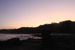 a sunset on the shore of a beach at Hotel La Cascada in Puntarenas